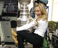 Hayden Panettiere thrusting up on a huge trophy.